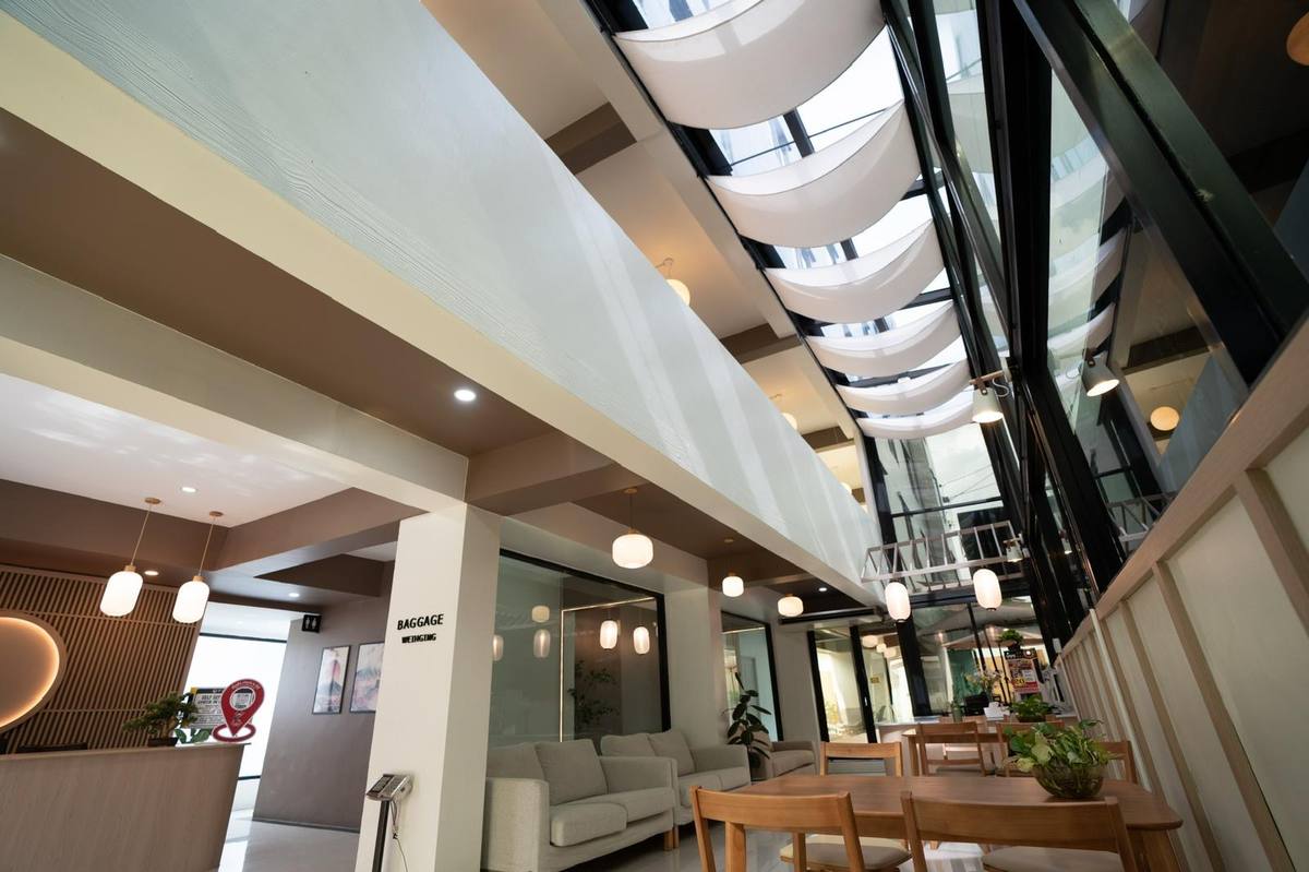 Light-filled atrium corridor with round paper lanterns