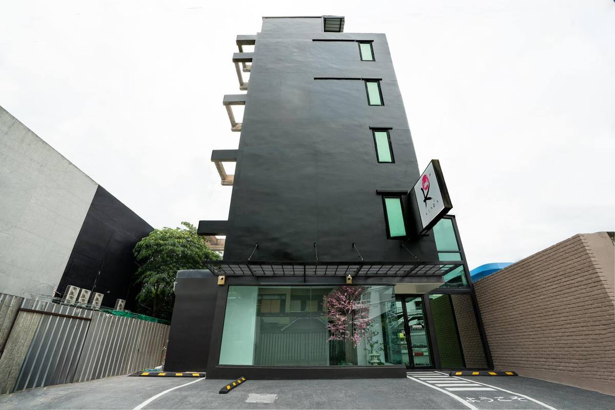 Kinza hotel exterior — modern charcoal facade