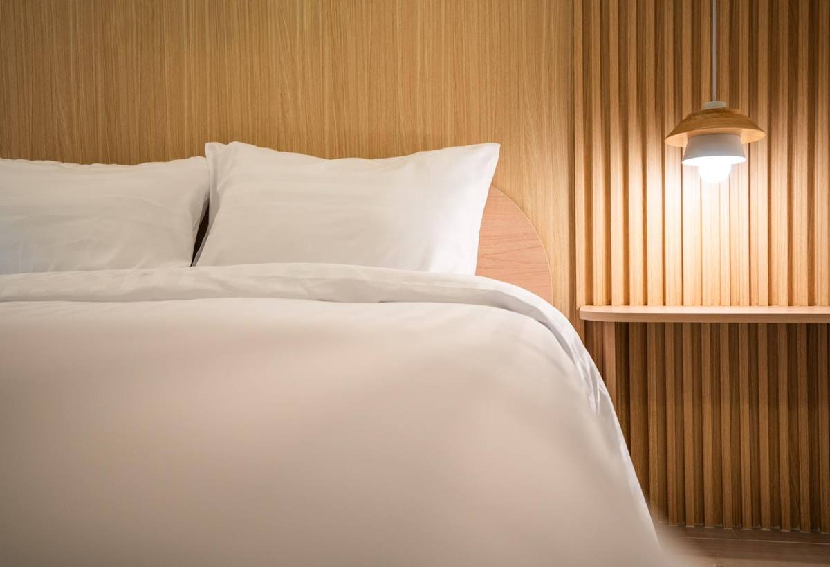 Close-up of bed linen and pendant lamp