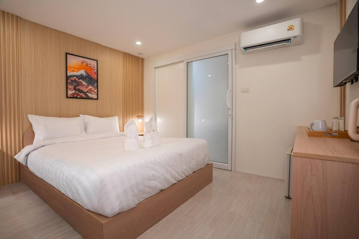 Deluxe Double room with queen bed and wood-slat headboard